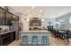 A spacious kitchen features dark wood cabinetry, granite countertops, a large island, and stainless steel appliances at 5068 Inshore Landing Dr, Apollo Beach, FL 33572