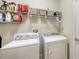 Laundry room featuring a washer, a dryer, and storage shelves at 5068 Inshore Landing Dr, Apollo Beach, FL 33572