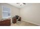 Home office with neutral carpet, a ceiling fan, and a large desk area with a computer setup at 5068 Inshore Landing Dr, Apollo Beach, FL 33572