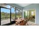 Covered, screened patio with brick floor and wood dining furniture with lush yard views at 5068 Inshore Landing Dr, Apollo Beach, FL 33572