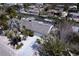 Aerial view showcasing a waterfront home with boat dockage, lush landscaping, and screened enclosure at 552 Juan Anasco Drive, Longboat Key, FL 34228