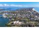 Stunning aerial view of waterfront homes in a coastal community with serene water views under a partly cloudy sky at 552 Juan Anasco Drive, Longboat Key, FL 34228