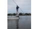 A Personal and dog standing on a boat, with other waterfront homes in the background at 552 Juan Anasco Drive, Longboat Key, FL 34228