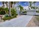 Lovely one-story home featuring a manicured yard, long driveway and an attached garage at 552 Juan Anasco Drive, Longboat Key, FL 34228