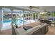 Relaxing lanai with a refreshing pool overlooking a canal, perfect for outdoor enjoyment at 552 Juan Anasco Drive, Longboat Key, FL 34228