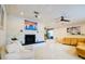 Bright living room with painted brick fireplace, modern lighting, and open floor plan at 552 Juan Anasco Drive, Longboat Key, FL 34228