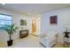 Bright living room with a wood door, neutral walls, recessed lighting, a small table, and indoor plants at 552 Juan Anasco Drive, Longboat Key, FL 34228