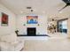 Bright living room with painted brick fireplace, open layout, and modern ceiling fan at 552 Juan Anasco Drive, Longboat Key, FL 34228