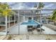Private screened-in pool area features lounge chairs and nearby boat dock at 552 Juan Anasco Drive, Longboat Key, FL 34228