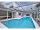 Stunning pool with seamless indoor-outdoor living, complemented by comfortable seating and serene waterfront views at 552 Juan Anasco Drive, Longboat Key, FL 34228