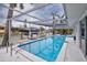 Relaxing pool area featuring a screened enclosure, waterfront views, and a convenient boat lift for easy water access at 552 Juan Anasco Drive, Longboat Key, FL 34228