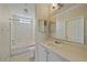 Neutral bathroom featuring a shower-tub, single sink vanity, and a pendant light fixture at 5601 Bentgrass Dr # 10-115, Sarasota, FL 34235