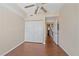 Bedroom featuring wood floors, closet and doorway leading to the staircase at 5601 Bentgrass Dr # 10-115, Sarasota, FL 34235