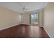 Spacious bedroom with a ceiling fan, sliding glass doors to a balcony, and large window at 5601 Bentgrass Dr # 10-115, Sarasota, FL 34235