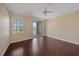 Spacious bedroom with a ceiling fan, sliding glass doors to a balcony, and large window at 5601 Bentgrass Dr # 10-115, Sarasota, FL 34235