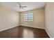 Comfortable bedroom with wood floors, a ceiling fan, and a bright window at 5601 Bentgrass Dr # 10-115, Sarasota, FL 34235