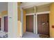 Charming townhouse entrance featuring colorful accent walls, a welcome mat and a wreath at 5601 Bentgrass Dr # 10-115, Sarasota, FL 34235