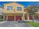 Townhome exterior showing garages, unit numbers, and well-maintained landscaping at 5601 Bentgrass Dr # 10-115, Sarasota, FL 34235