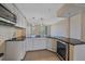 Modern kitchen featuring white cabinets, granite countertops, and stainless steel appliances at 5601 Bentgrass Dr # 10-115, Sarasota, FL 34235