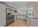 Modern kitchen featuring white cabinets, granite countertops, and stainless steel appliances at 5601 Bentgrass Dr # 10-115, Sarasota, FL 34235