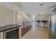 Open concept living with wine storage, kitchen, dining and staircase to the second floor at 5601 Bentgrass Dr # 10-115, Sarasota, FL 34235