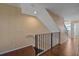 Bright staircase with hardwood floors and modern railing leads to upper level at 5601 Bentgrass Dr # 10-115, Sarasota, FL 34235