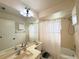 Bright bathroom featuring a large mirror, and a shower with a curtain at 5638 Garden Lakes Palm, Bradenton, FL 34203