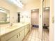 Bathroom featuring dual sinks, large vanity mirror and tile floor at 5638 Garden Lakes Palm, Bradenton, FL 34203