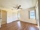 Bedroom has wood floor, closet, two windows allowing for exterior views, and door to the bathroom at 5638 Garden Lakes Palm, Bradenton, FL 34203