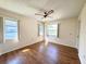 Well-lit bedroom features wood floors, ceiling fan, and two windows that offer exterior views at 5638 Garden Lakes Palm, Bradenton, FL 34203