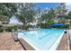 Large community swimming pool surrounded by lounge chairs and mature trees at 5638 Garden Lakes Palm, Bradenton, FL 34203