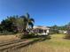 View of the exterior of this charming home, showcasing mature landscaping and a well-maintained lawn at 5638 Garden Lakes Palm, Bradenton, FL 34203