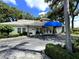 Exterior of home featuring a covered entry, manicured landscaping and paved driveway at 5638 Garden Lakes Palm, Bradenton, FL 34203