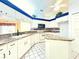 Well-lit kitchen with white cabinetry, modern appliances, and breakfast bar at 5638 Garden Lakes Palm, Bradenton, FL 34203