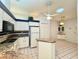 Open concept kitchen with an eat-in area, tiled floors, white cabinets and modern appliances at 5638 Garden Lakes Palm, Bradenton, FL 34203