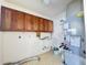 A utility sink and overhead cabinets are present in this laundry room at 5638 Garden Lakes Palm, Bradenton, FL 34203