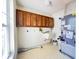 Utility room featuring ample storage, sink, and convenient laundry hookups at 5638 Garden Lakes Palm, Bradenton, FL 34203