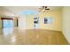Bright living room with tile flooring, ceiling fan, and a clear view to the kitchen at 5638 Garden Lakes Palm, Bradenton, FL 34203