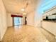 Open-concept living room features tile flooring and sliding glass doors to the screened lanai at 5638 Garden Lakes Palm, Bradenton, FL 34203