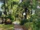 Scenic community path lined with lush tropical foliage and mature trees at 5638 Garden Lakes Palm, Bradenton, FL 34203