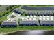 Aerial view of townhomes showcasing landscaping, pond and neighborhood at 5734 Archipelago St, Nokomis, FL 34275