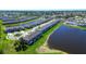 Aerial view of townhomes in a lakeside community with lush landscaping and tranquil water features at 5734 Archipelago St, Nokomis, FL 34275