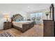 Serene bedroom with neutral carpeting, a large window, and stylish furniture at 5734 Archipelago St, Nokomis, FL 34275