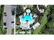 Aerial view of community pool surrounded by tropical plants, lounging area, and parking at 5734 Archipelago St, Nokomis, FL 34275