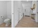 Neutral entryway with a half bathroom, light tile flooring, and an entry door with sidelights at 5734 Archipelago St, Nokomis, FL 34275