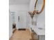 Bright foyer with decorative mirror, stylish console table and fresh floral arrangement at 5734 Archipelago St, Nokomis, FL 34275
