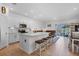 Modern, open kitchen with a large center island, white cabinetry, and views to the lake at 5734 Archipelago St, Nokomis, FL 34275