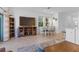 Open-concept living room with tile floors, modern furnishings, and a dining area by bright windows at 5734 Archipelago St, Nokomis, FL 34275