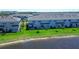 Lakeside townhomes feature a manicured lawn, and patio area perfect for outdoor relaxation at 5734 Archipelago St, Nokomis, FL 34275