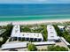 Stunning aerial view of beachfront condos, showcasing beautiful beaches and ocean views at 5757 Gulf Of Mexico Dr # 110, Longboat Key, FL 34228